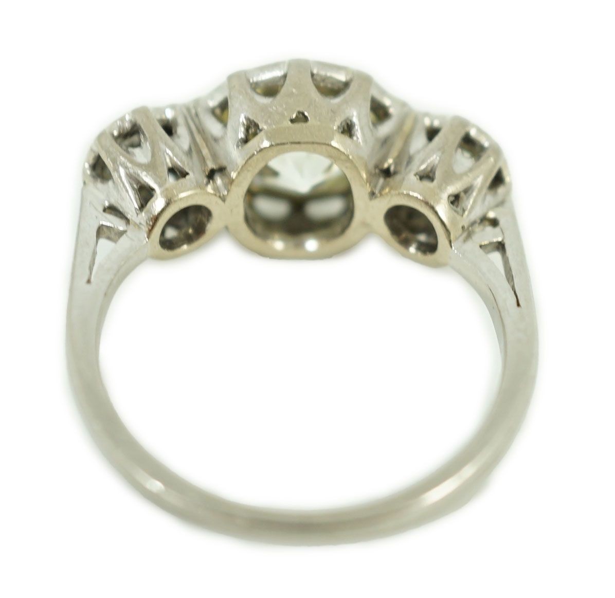A white gold and collet set three stone diamond ring, the central stone weight approximately 2.08ct